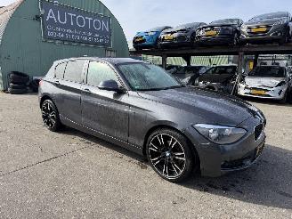 damaged passenger cars BMW 1-serie 116i Autom. 100KW Clima Navi 5-Drs 2012/2